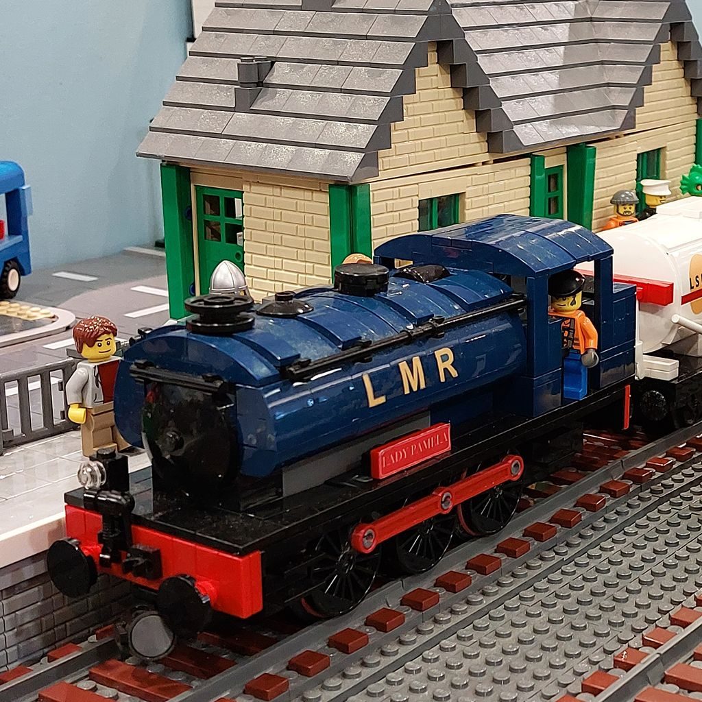 A LEGO model of the steam engine LMR Lady Pamela beside a LEGO station building, from the Spa Valley Model Brick Show